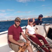Team Building- Offshore Sailing Academy Students with bright Smiles on their faces enjoying a sunny day with blue sky on the Indian ocean with the Durban skyline on the Horizon