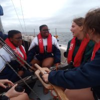 Day Skipper-A sunny day on the Indian Ocean and a crew of Offshore Sailing Academy students are Smiling at the Camera